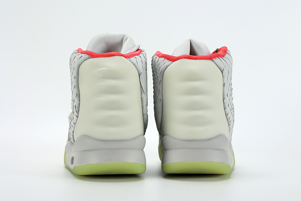 The Air Yeezy 2 NRG 'Pure Platinum' launched in June 2012 featuring a subdued colorway that blends varying shades of grey on the upper and a contrasting pop of bright red on the collar lining.